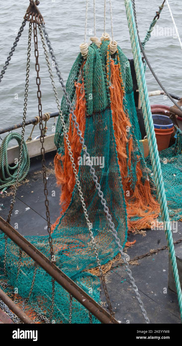 Colourful fishing nets drying on a trawler in Whitby harbour Stock Photo