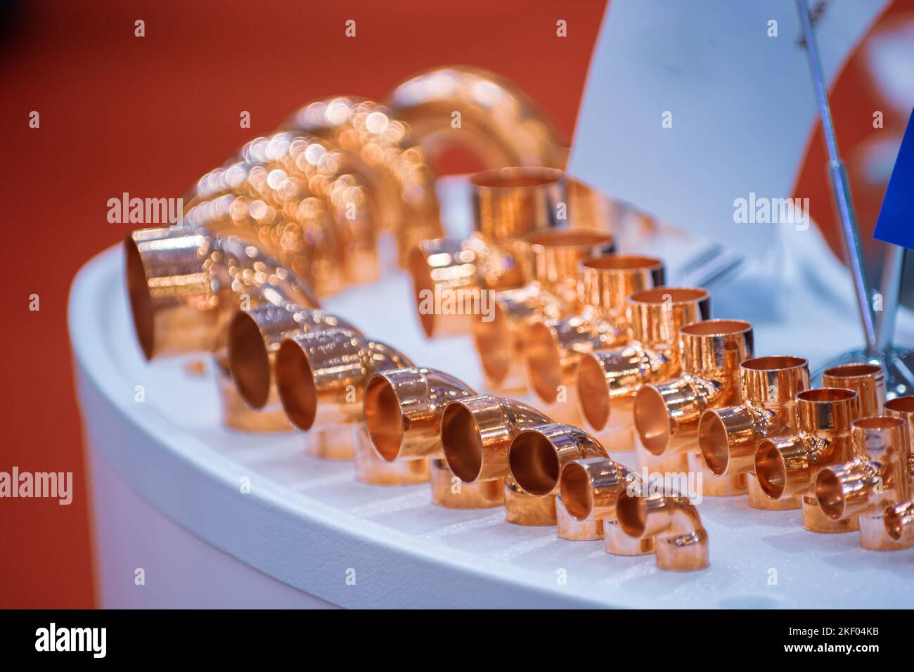 Copper pipe fittings. Set of connecting angle pipes made of copper. Stock Photo