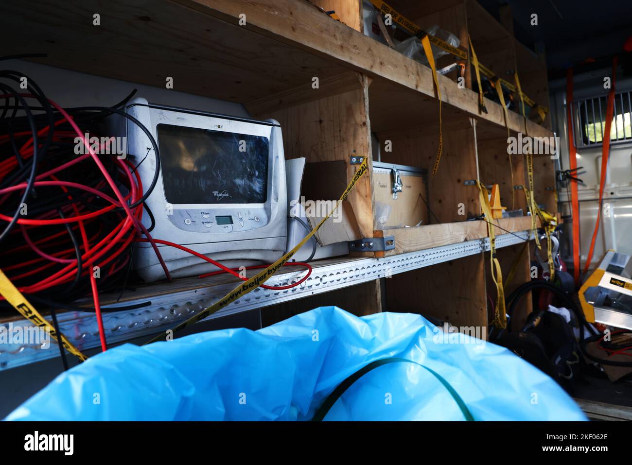 A craftsman's work bus with machines and work materials. In the picture: A microwave to heat food for the workers when they are on installation assignments. Stock Photo