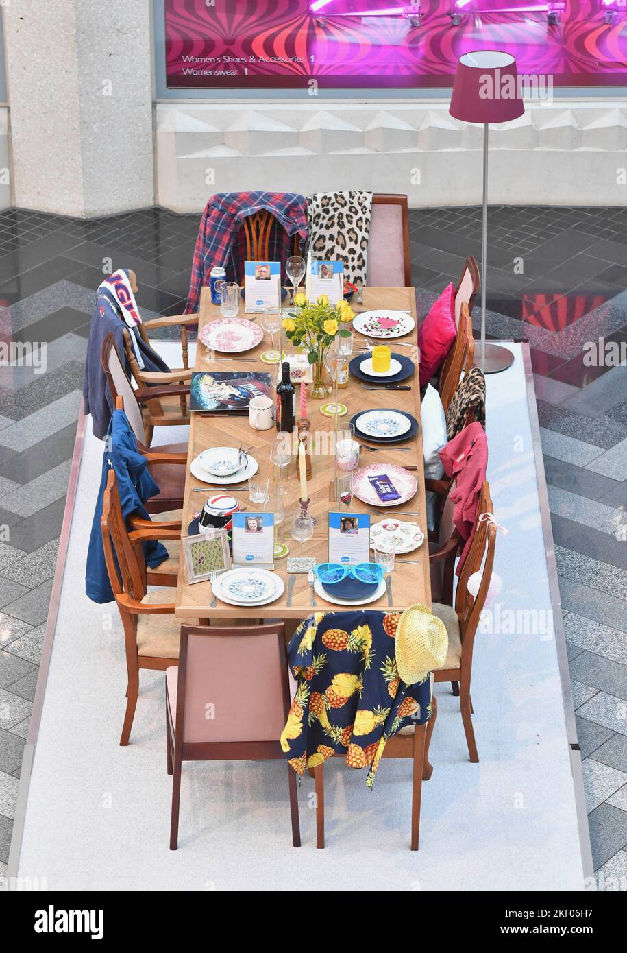 EDITORIAL USE ONLY A 13 seater dining table set for dinner without guests is unveiled by national bereavement charity Sue Ryder in Leeds each chair features a personal item to represent a