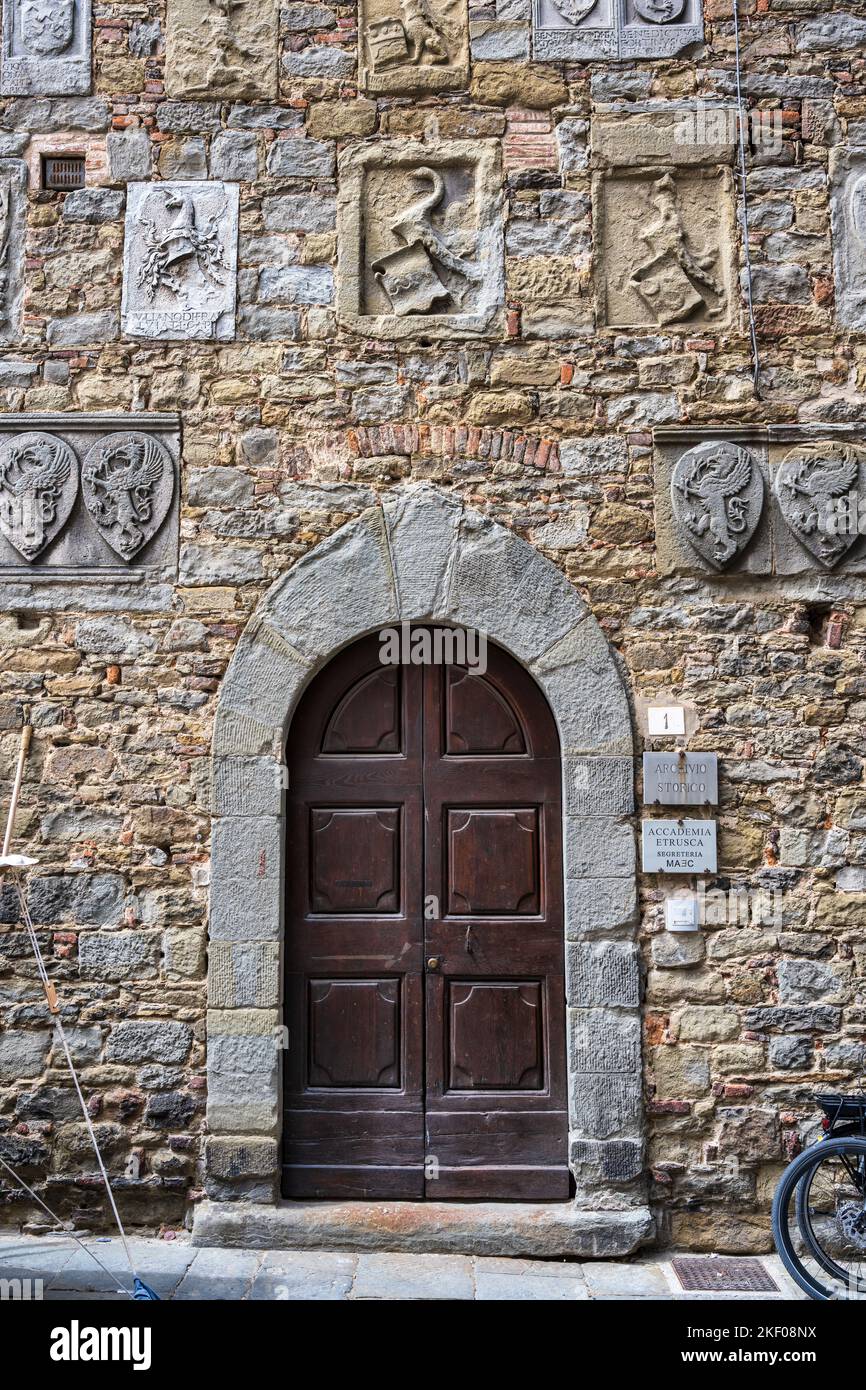 Side door of Palazzo Casali, which houses Museo dell’Accademia Etrusca, on Via Casali in hilltop town of Cortona in Tuscany, Italy Stock Photo