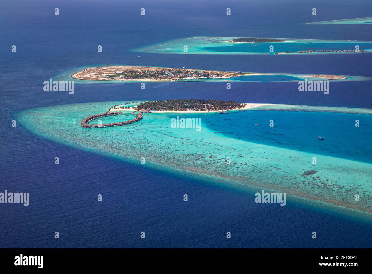Aerial photo of beautiful Maldives paradise tropical beach. Amazing view, blue turquoise lagoon water, palm trees and white sandy beach. Luxury travel Stock Photo