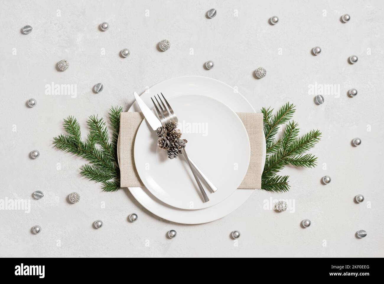 Christmas table setting with silver decorations Stock Photo - Alamy