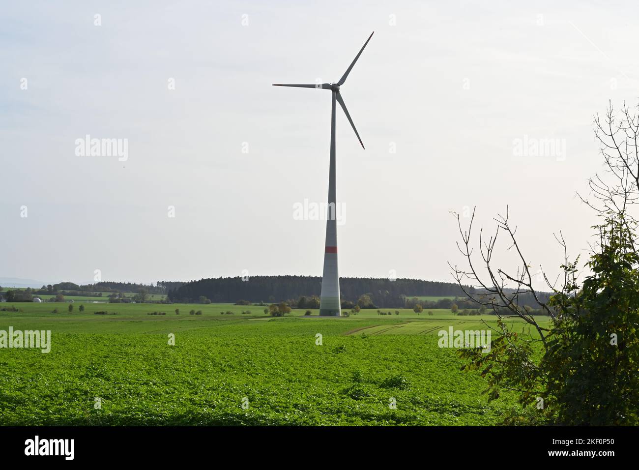 Single on-shore wind turbine situated in the field in German countryside. Stock Photo