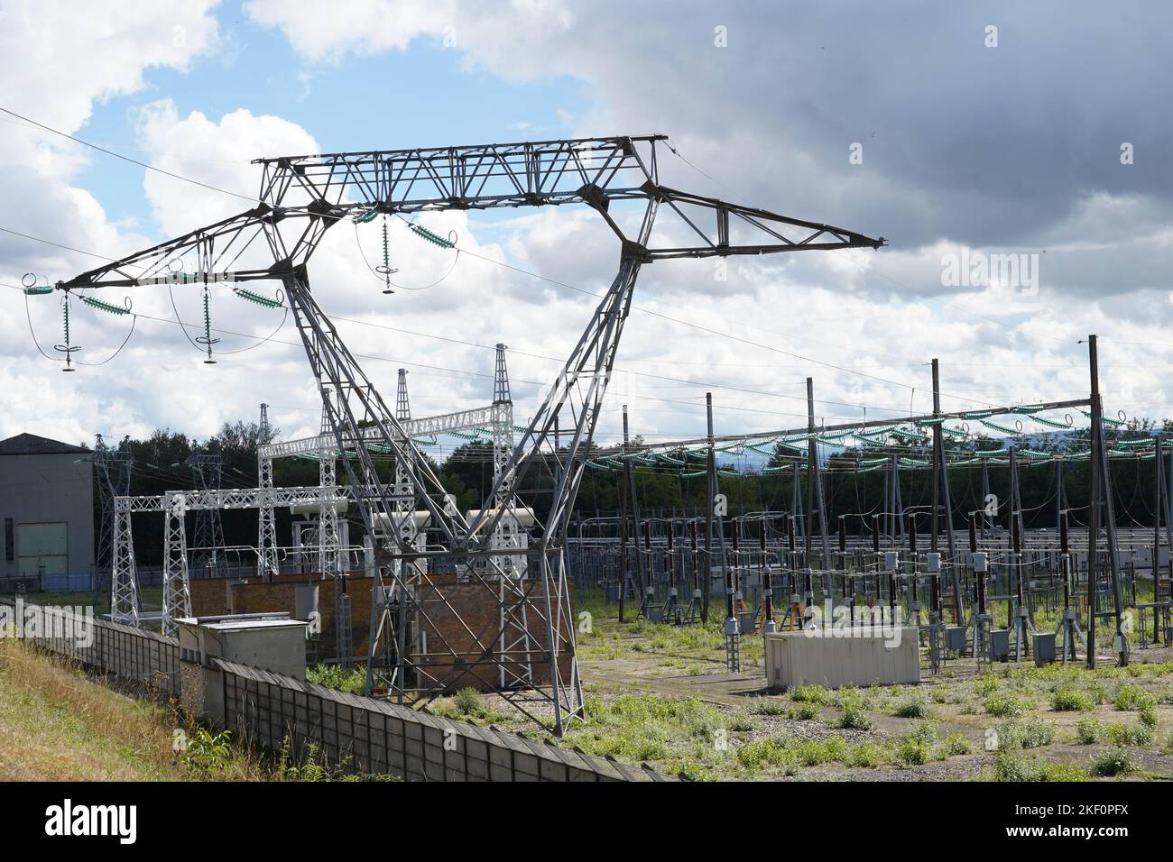 View on high voltage electricity power distribution plant and electricity pillars. Stock Photo