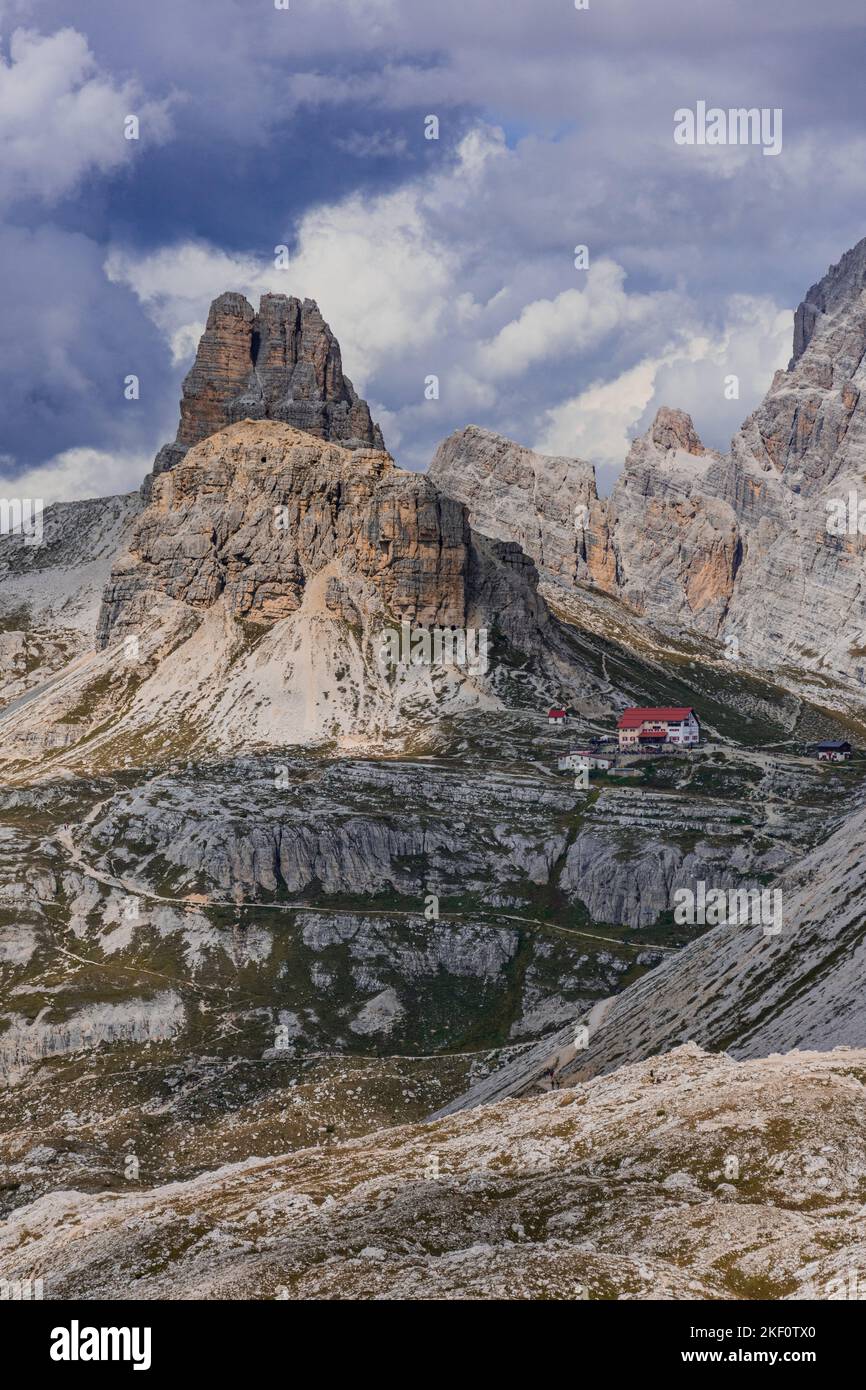 A vertical shot of rocky mountains under cloudy sky Stock Photo - Alamy