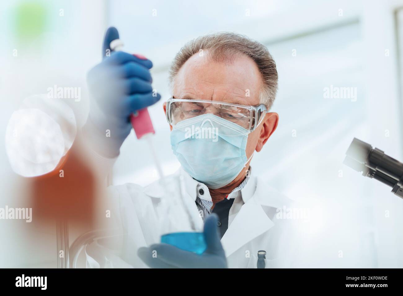 close up. researcher using an automatic dispenser in a medical ...