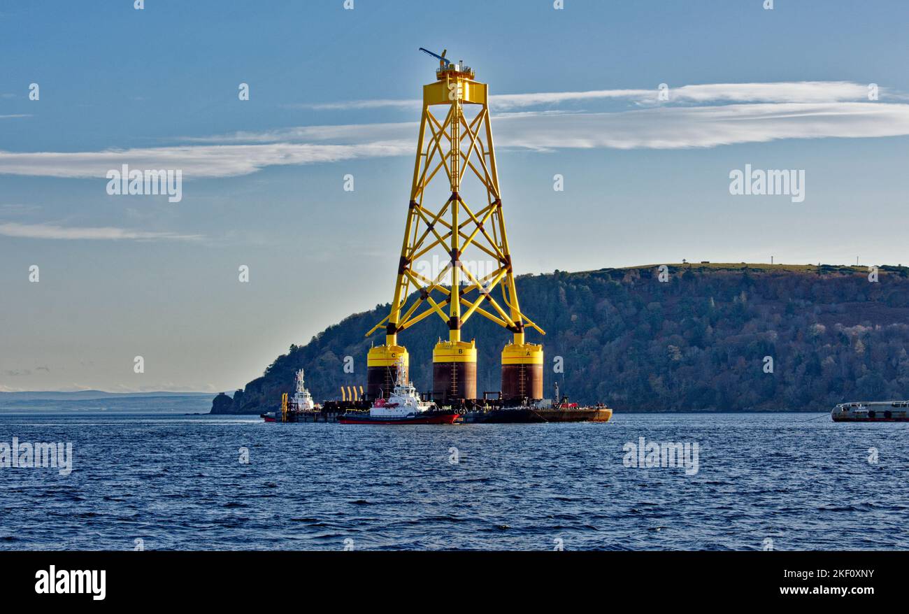 Cromarty Firth Nigg Scotland the yellow jacket base of an offshore wind turbine being towed past the Cromarty Sutor Stock Photo