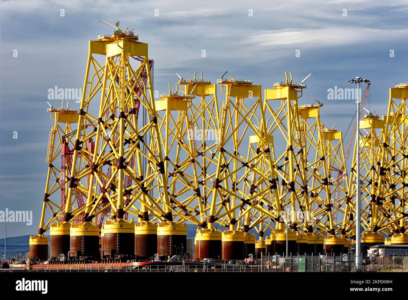 Cromarty Firth Scotland Nigg rows of new yellow bases or yellow jackets for off shore wind turbines Stock Photo