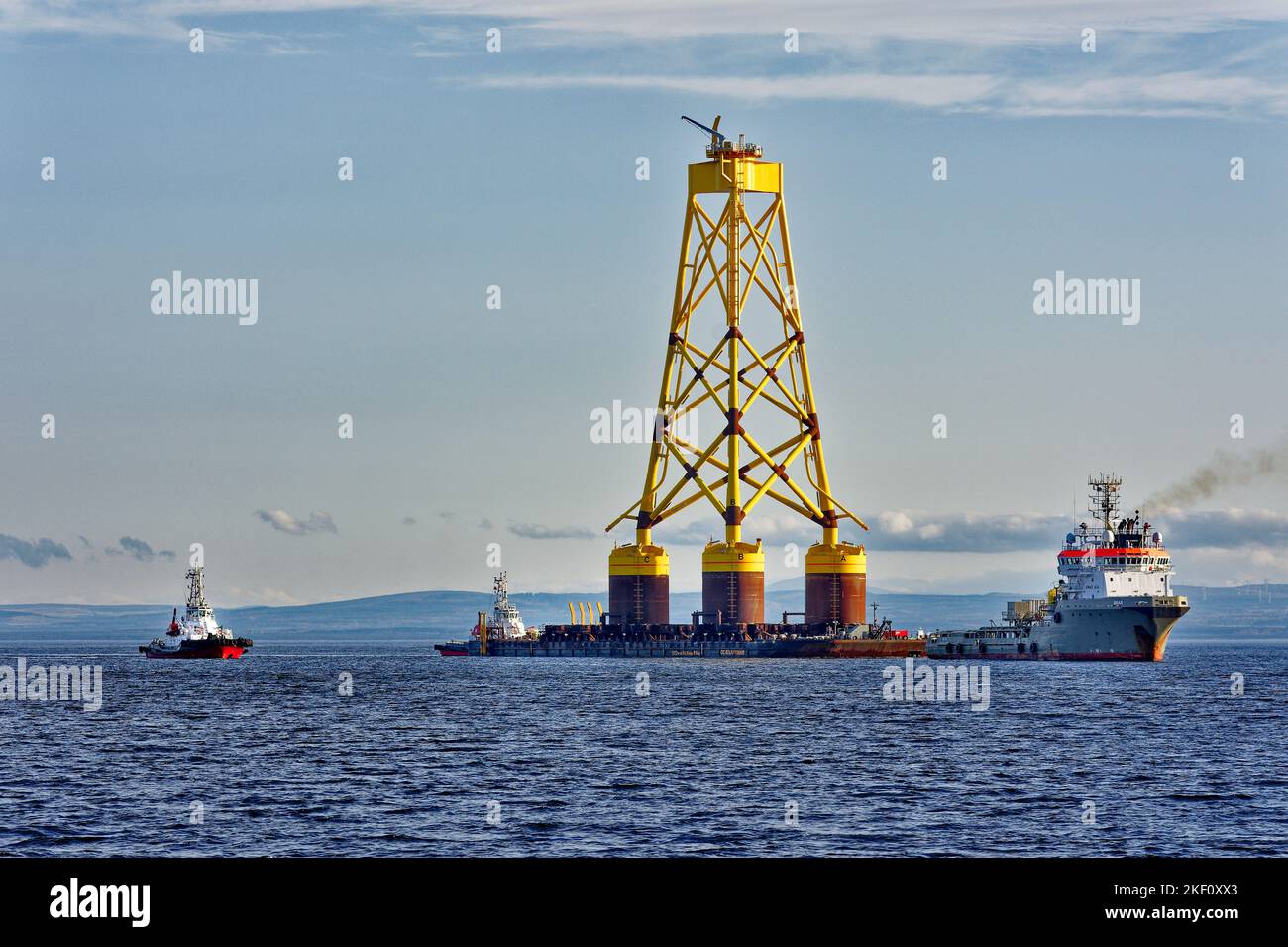 Cromarty Firth Scotland Nigg three tugs towing the yellow jacket base of an offshore wind turbine Stock Photo