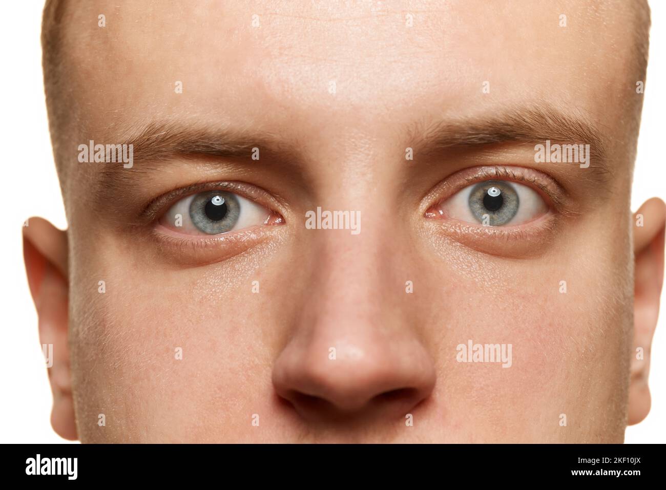 Closeup portrait of male grey eyes looking straight isolated over