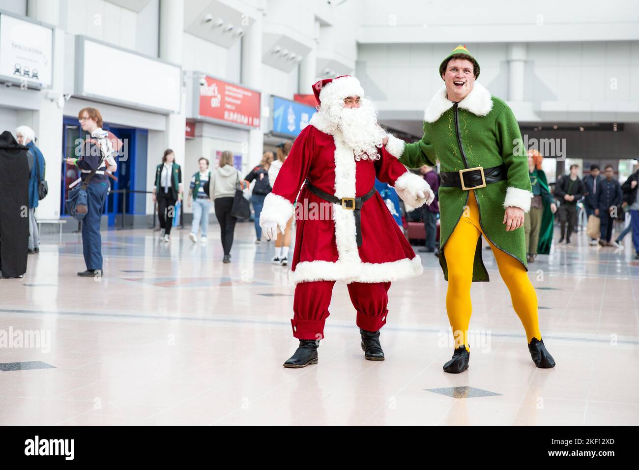 BIRMINGHAM NEC, UK - NOVEMBER 13, 2022.  A pair of male cosplayers dressed as Buddy The Elf and Santa Claus at MCM Birmingham Comic Con 2022 Stock Photo