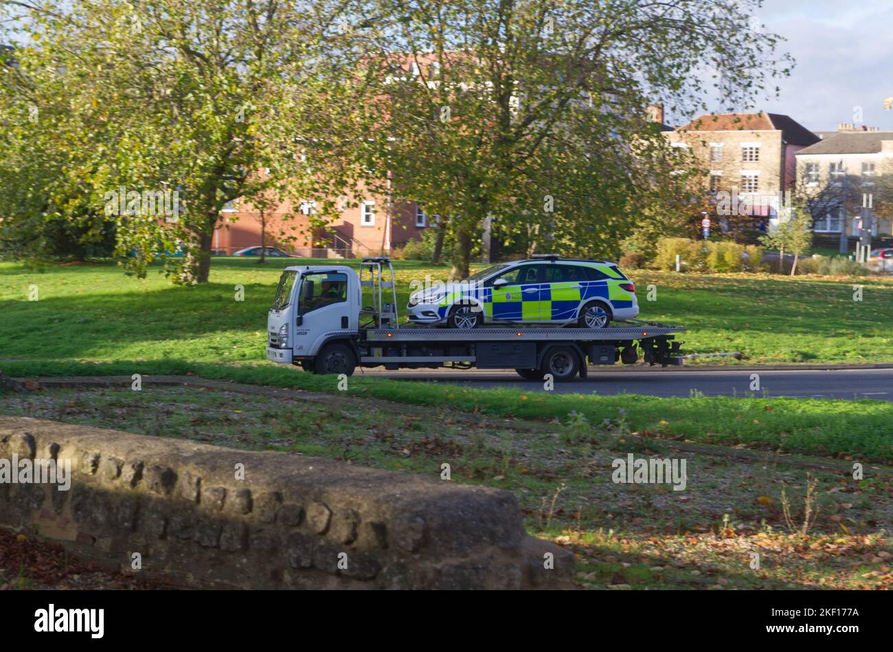 Police car being transported on the back of a truck in Colchester, Essex Stock Photo