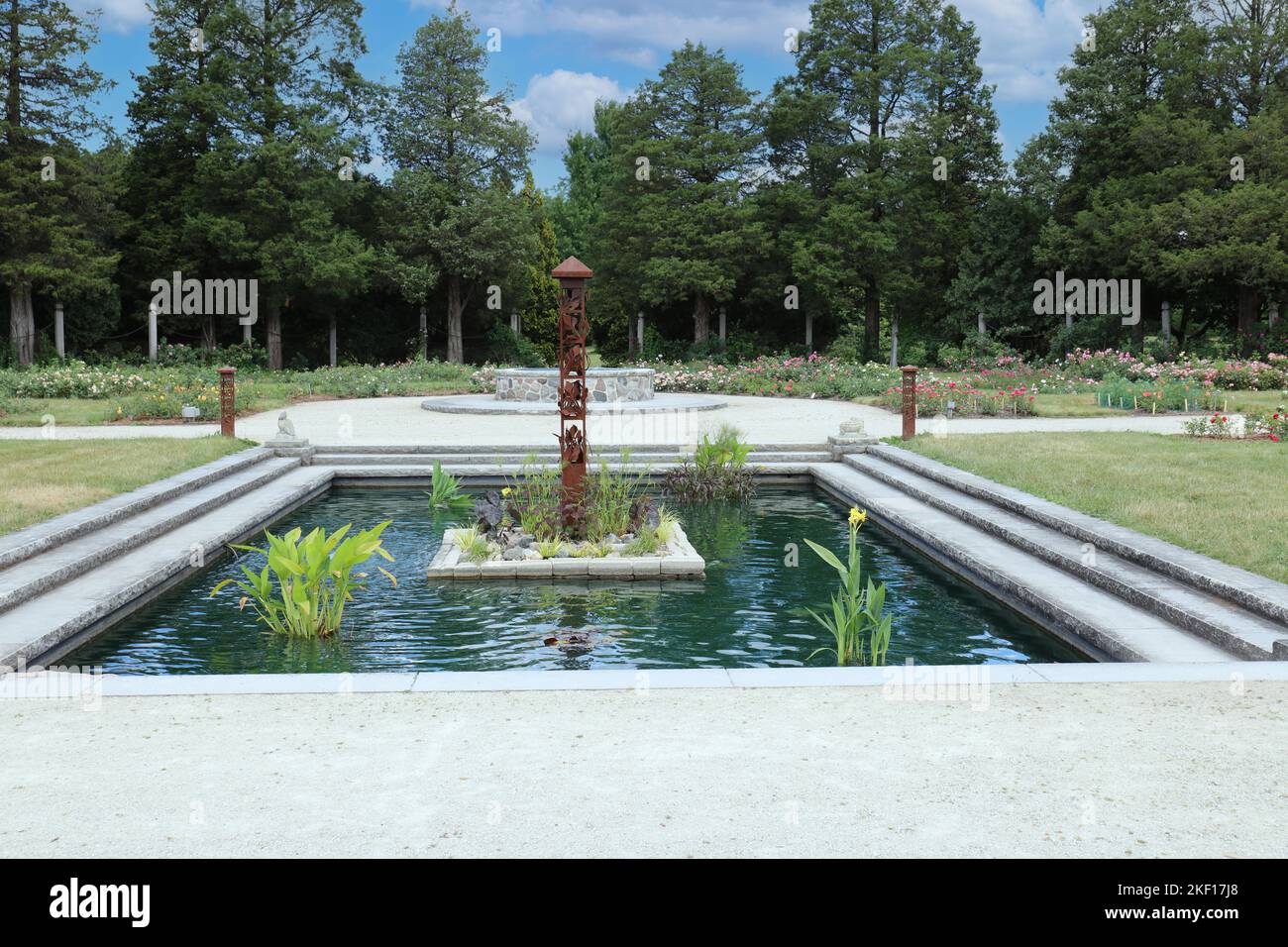 A man made pond with water plants and a sculpture at Boerner Botanical