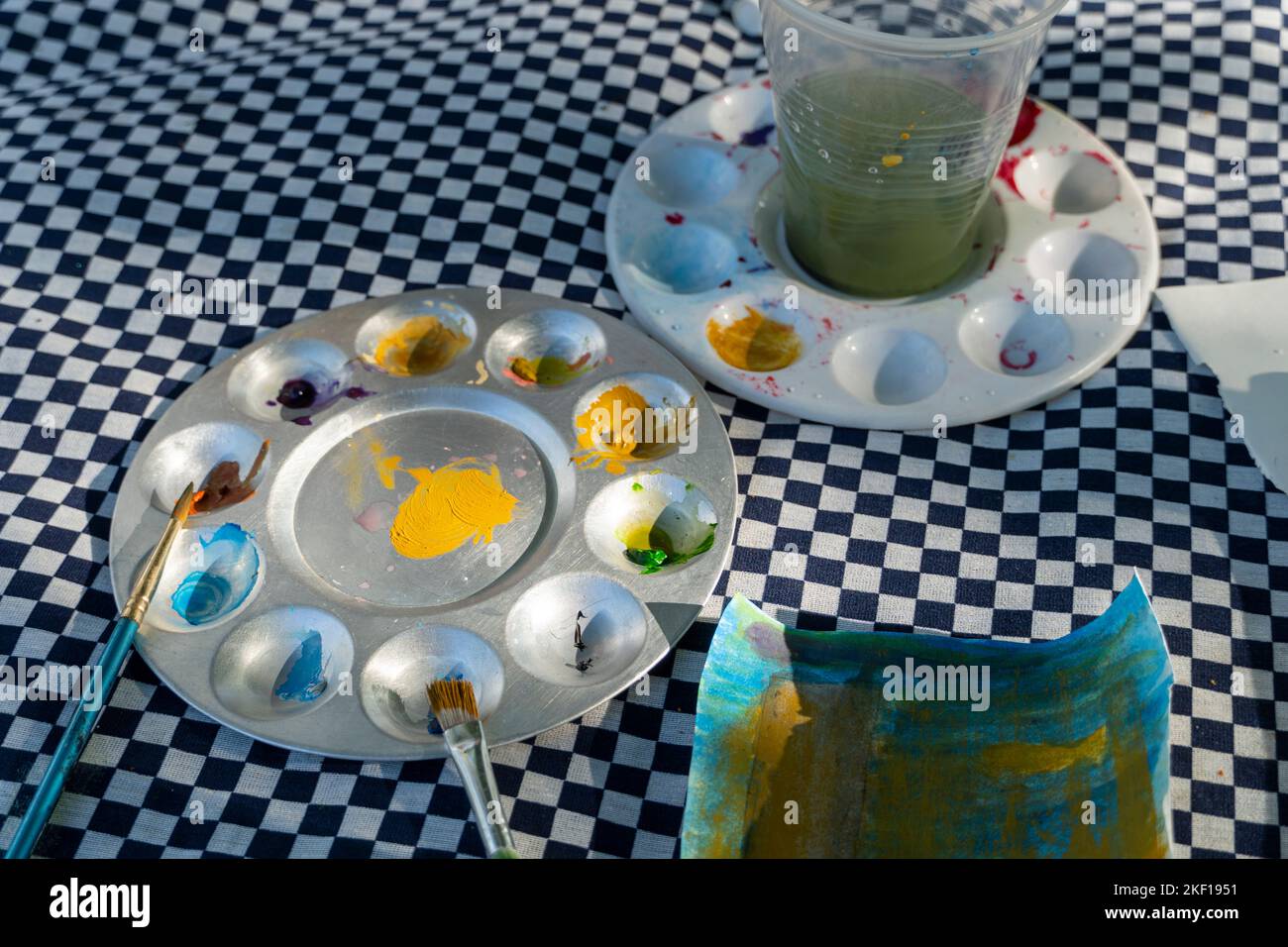 watercolor palette mix of different colors, brushes, paint on paper