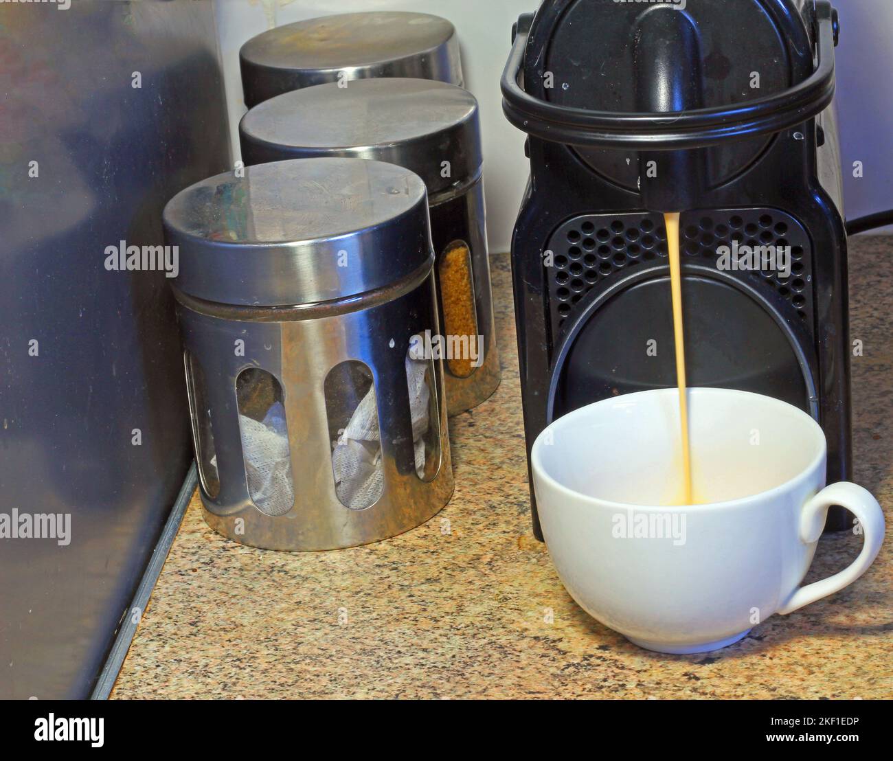 coffee being made in a n expresso coffee machine. Coffee running from