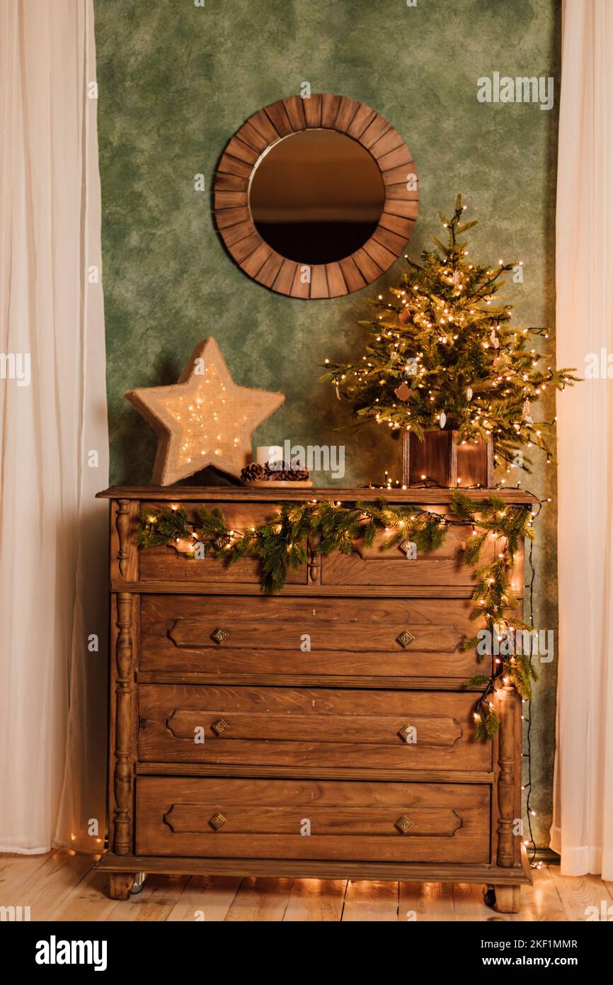 Antique wooden brown chest of drawers with Christmas decor Stock Photo