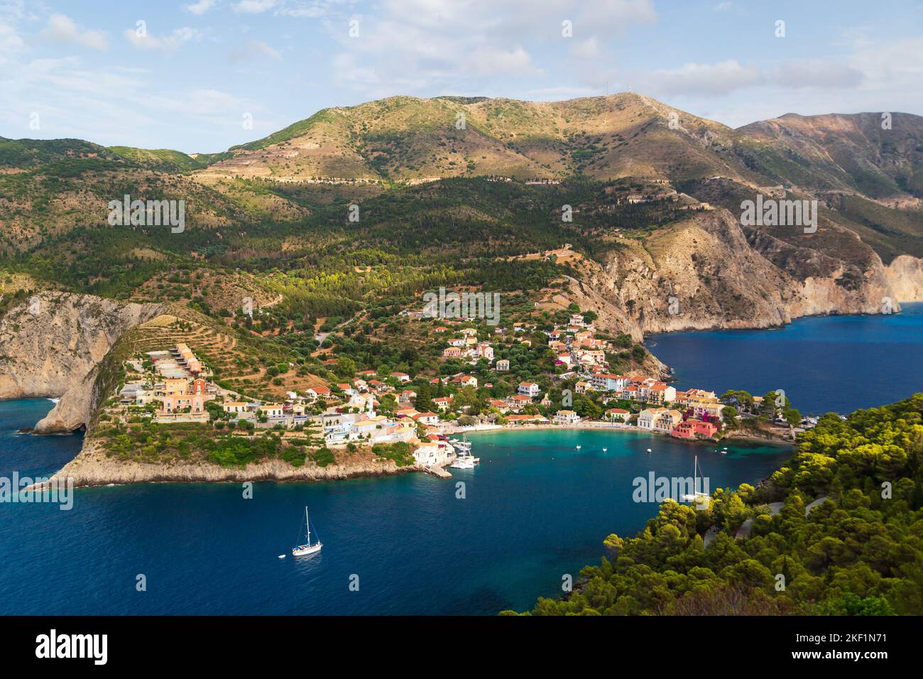 Fantastic top view at Asos village, Assos peninsula and blue Ionian Sea water. Aerial view, summer scenery of famous and extremely popular travel dest Stock Photo