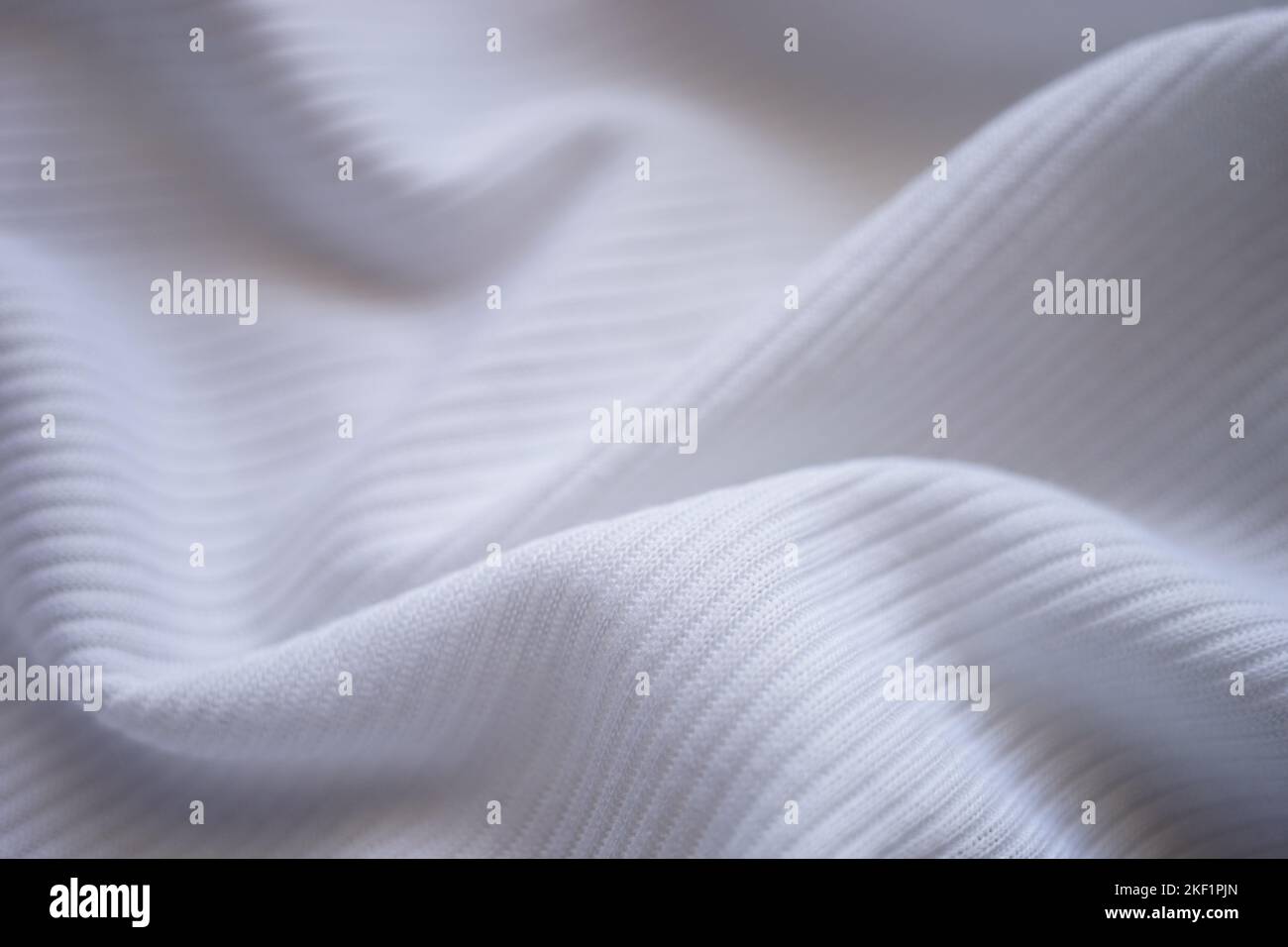 White wrinkled jersey, soft fabric background. Stock Photo