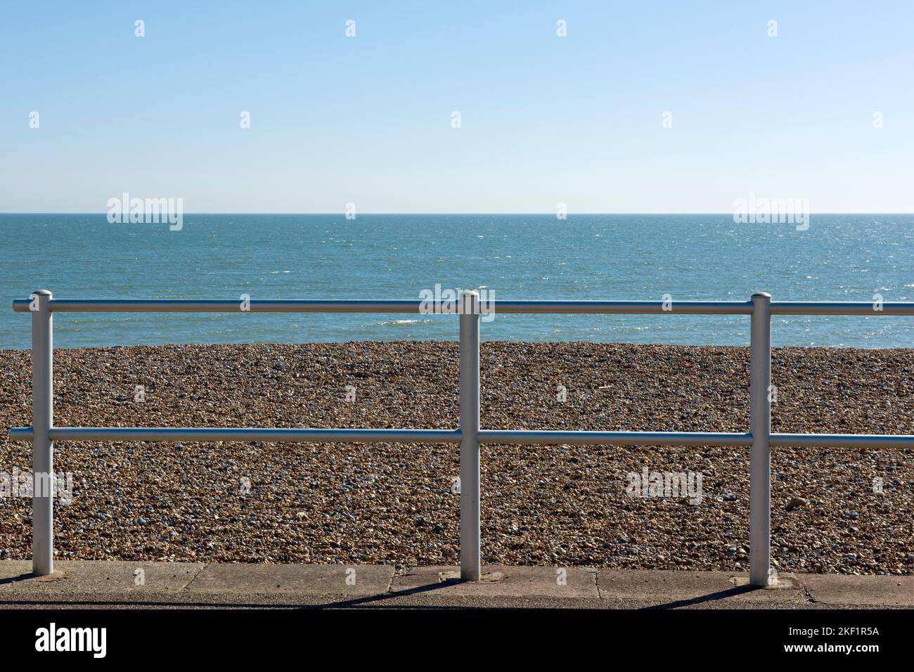Seaside fence and pebbles at Eastbourne, East Sussex, UK Stock Photo