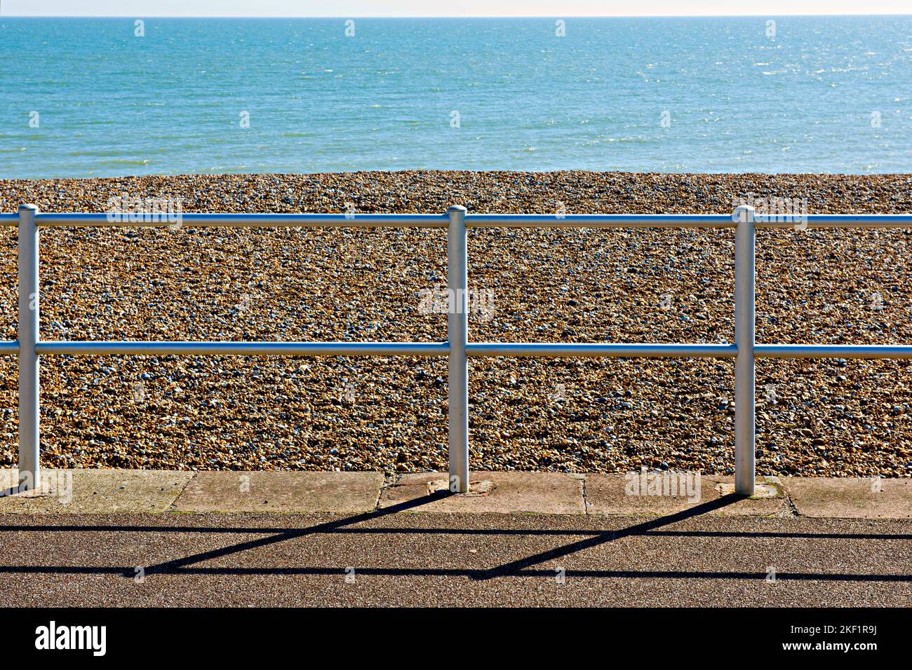 Seaside fence and pebbles at Eastbourne, East Sussex, UK Stock Photo