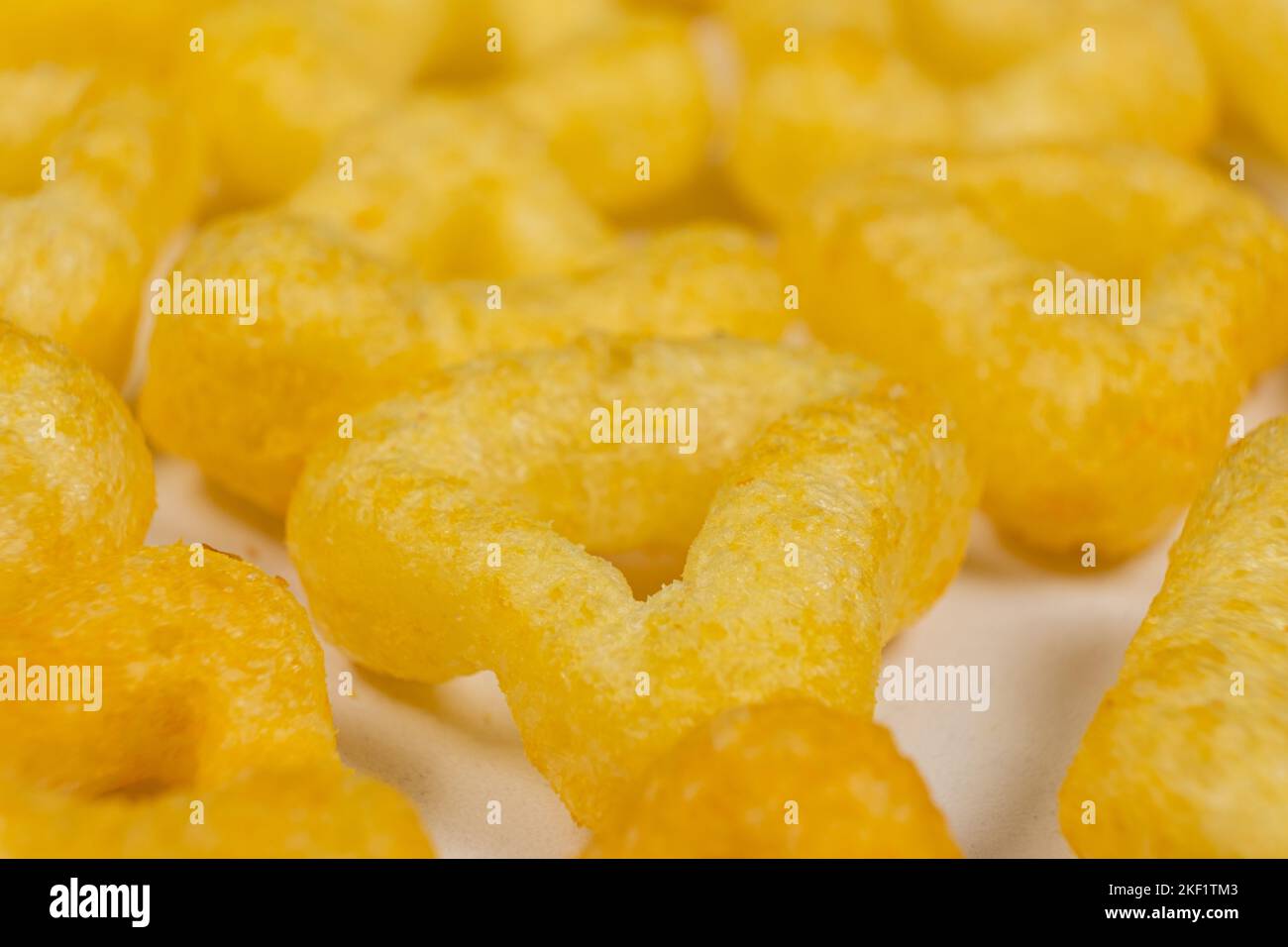 Delicious crispy corn chips triangular shape with spices, macro Stock