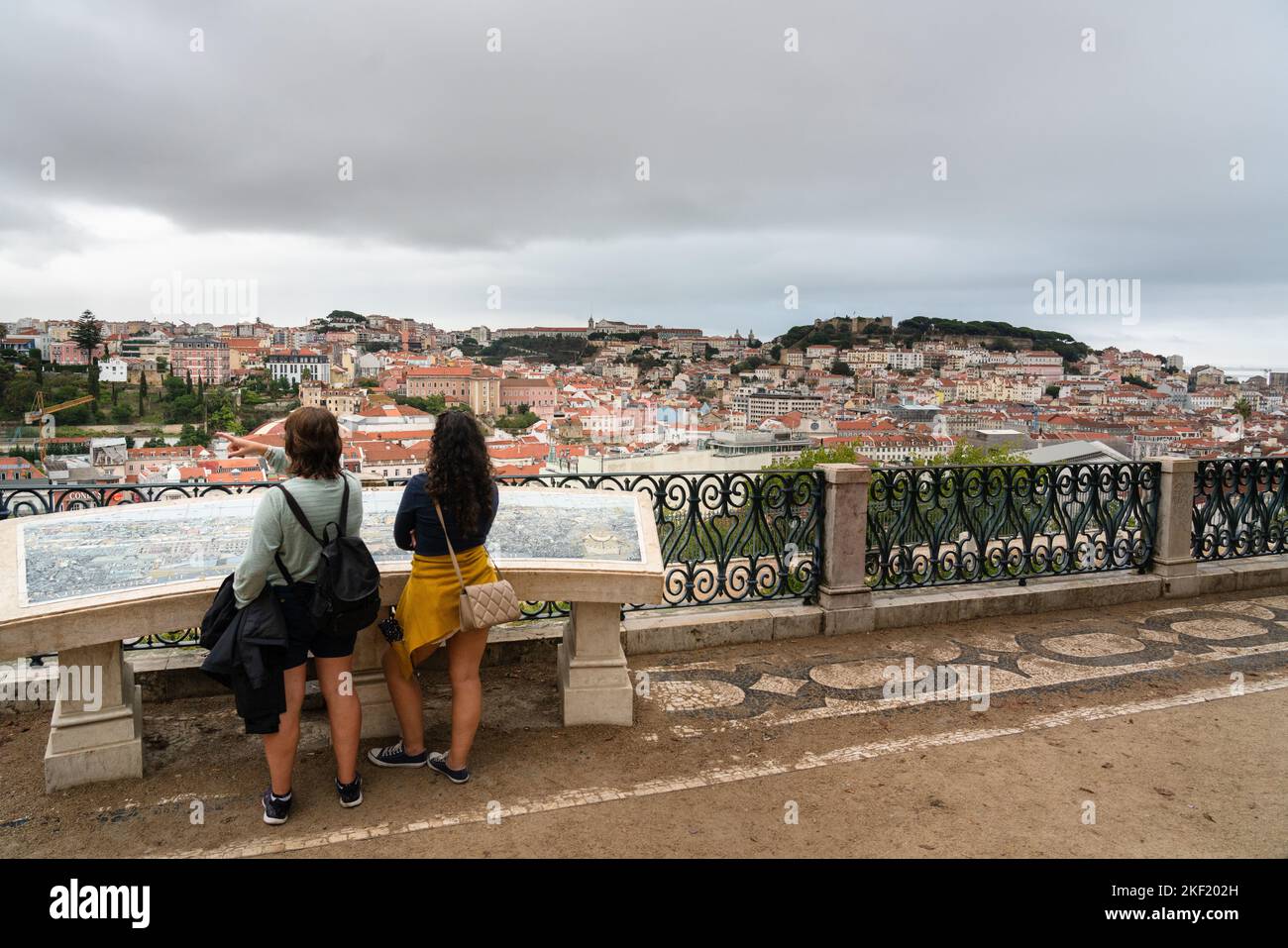 Tourists at large map at the Miradouro de São Pedro de Alcântara in Lisbon, Portugal. Stock Photo