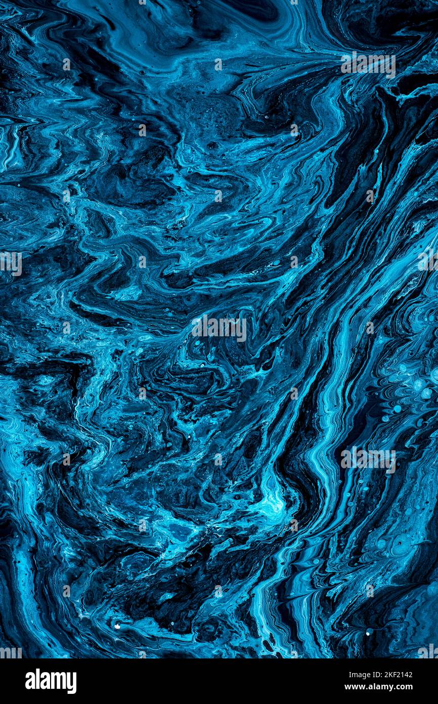 Free flowing blue and black acrylic paint. Random Waves and Curls. Abstract marble background, texture. Stock Photo
