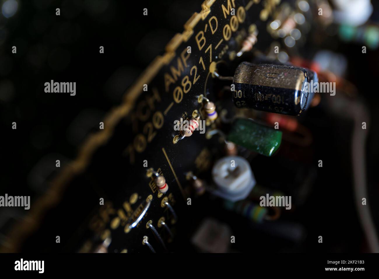 A close up portrait of a black electronic circuit board with the focus