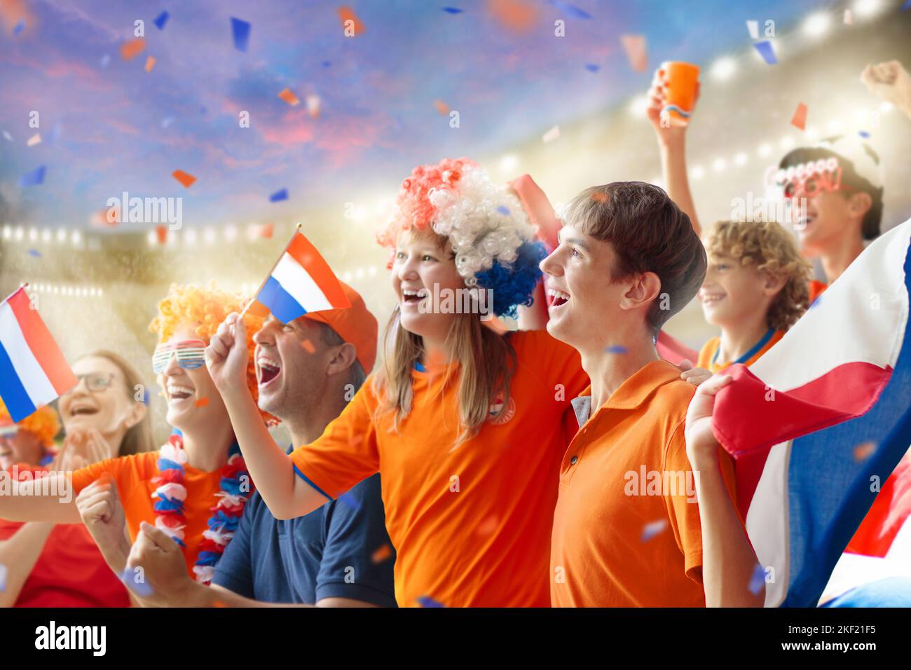 Netherlands football supporter on stadium. Dutch fans on soccer pitch