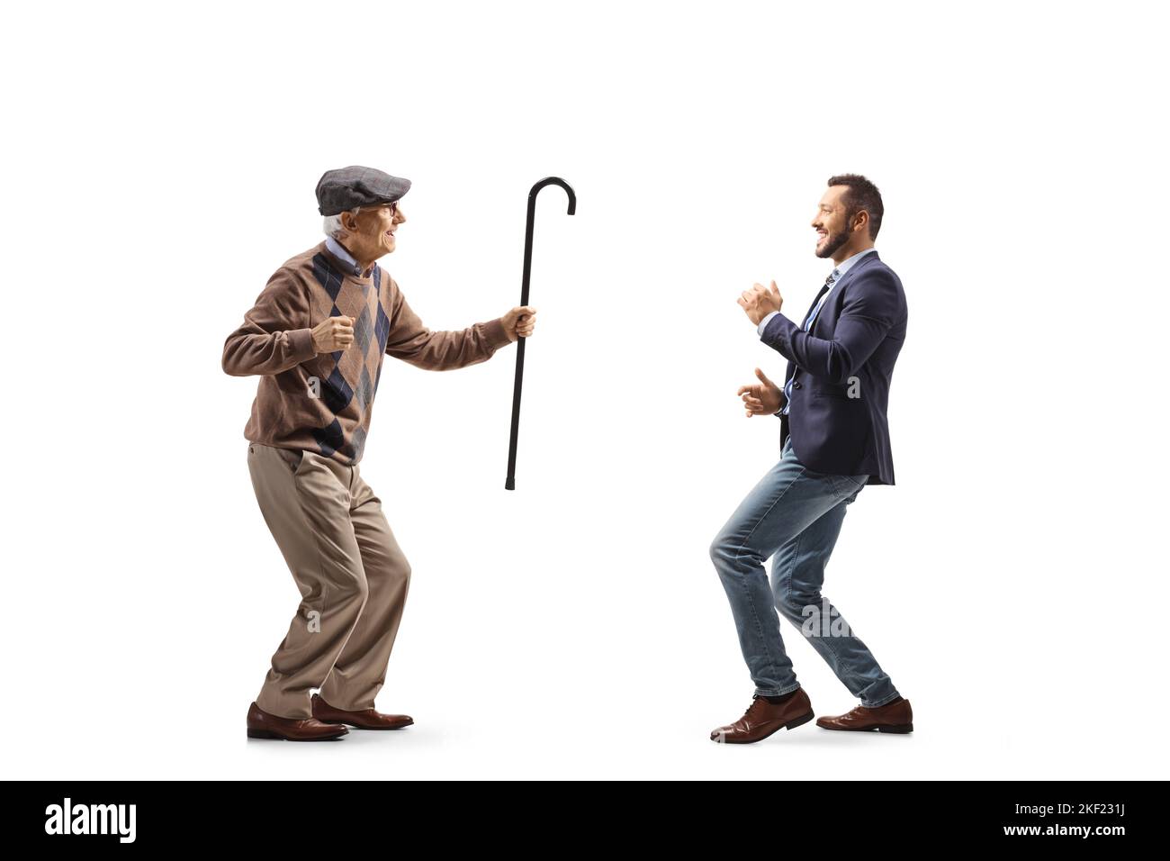 Full length profile shot of an elderly father dancing with his son isolated on white background Stock Photo