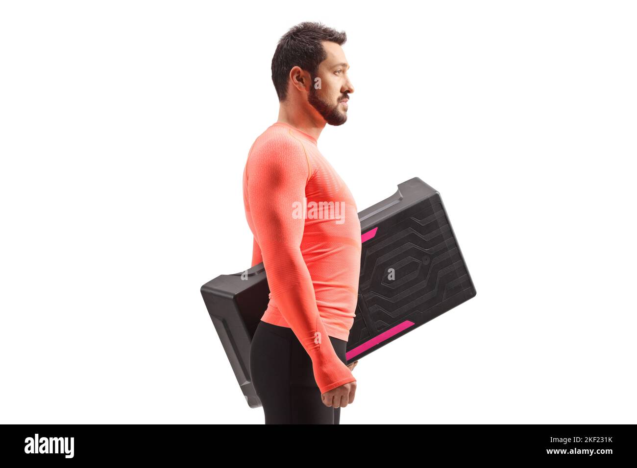 Man in sportswear holding a step aerobic platform isolataed on white background Stock Photo