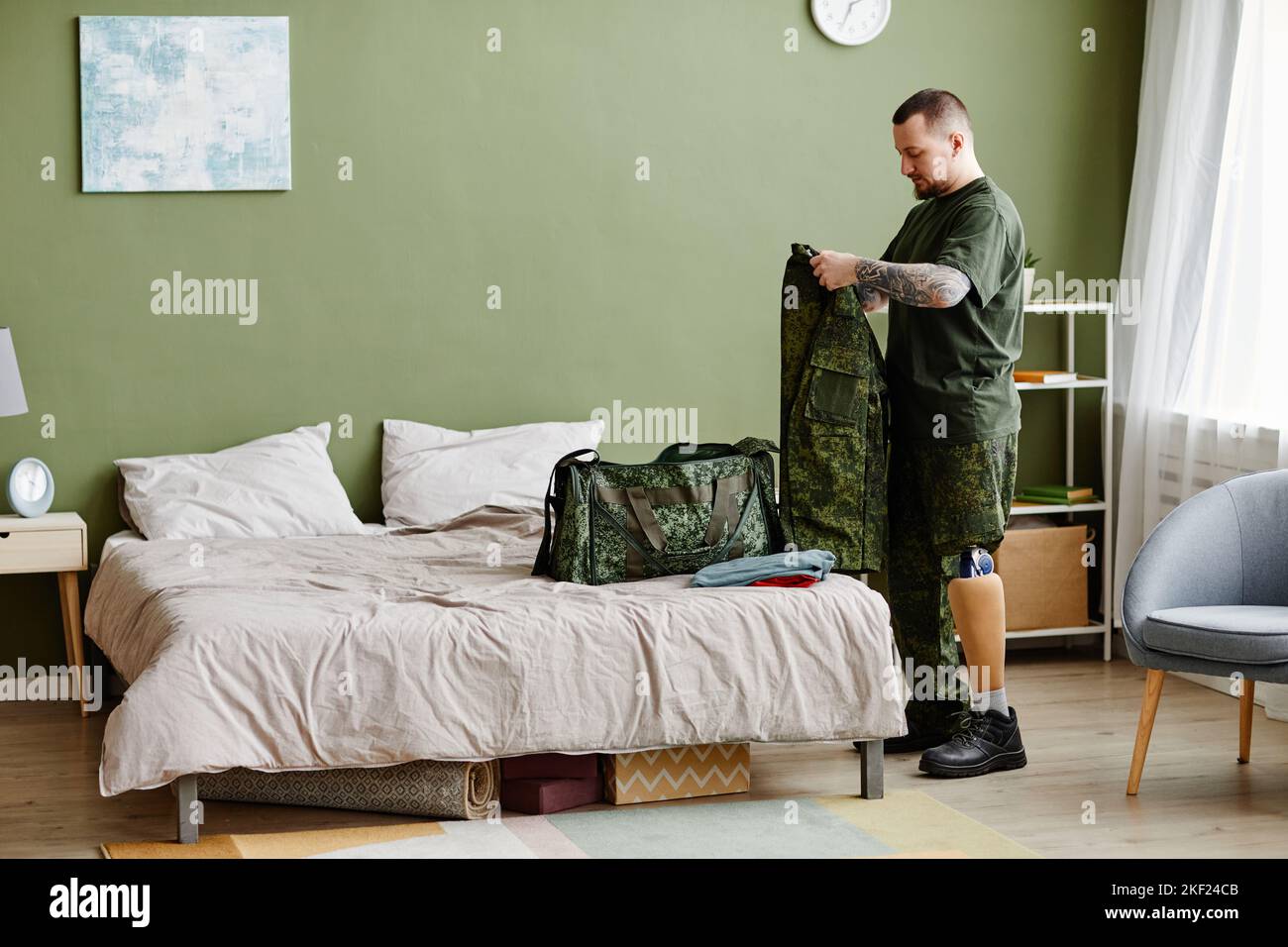 Full length portrait of military veteran with prosthetic leg packing