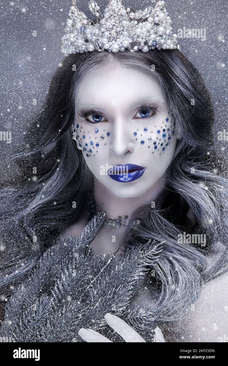 Snow Queen.Fantasy girl portrait. Winter fairy portrait.Young woman with creative silver artistic make-up. Winter portrait Stock Photo