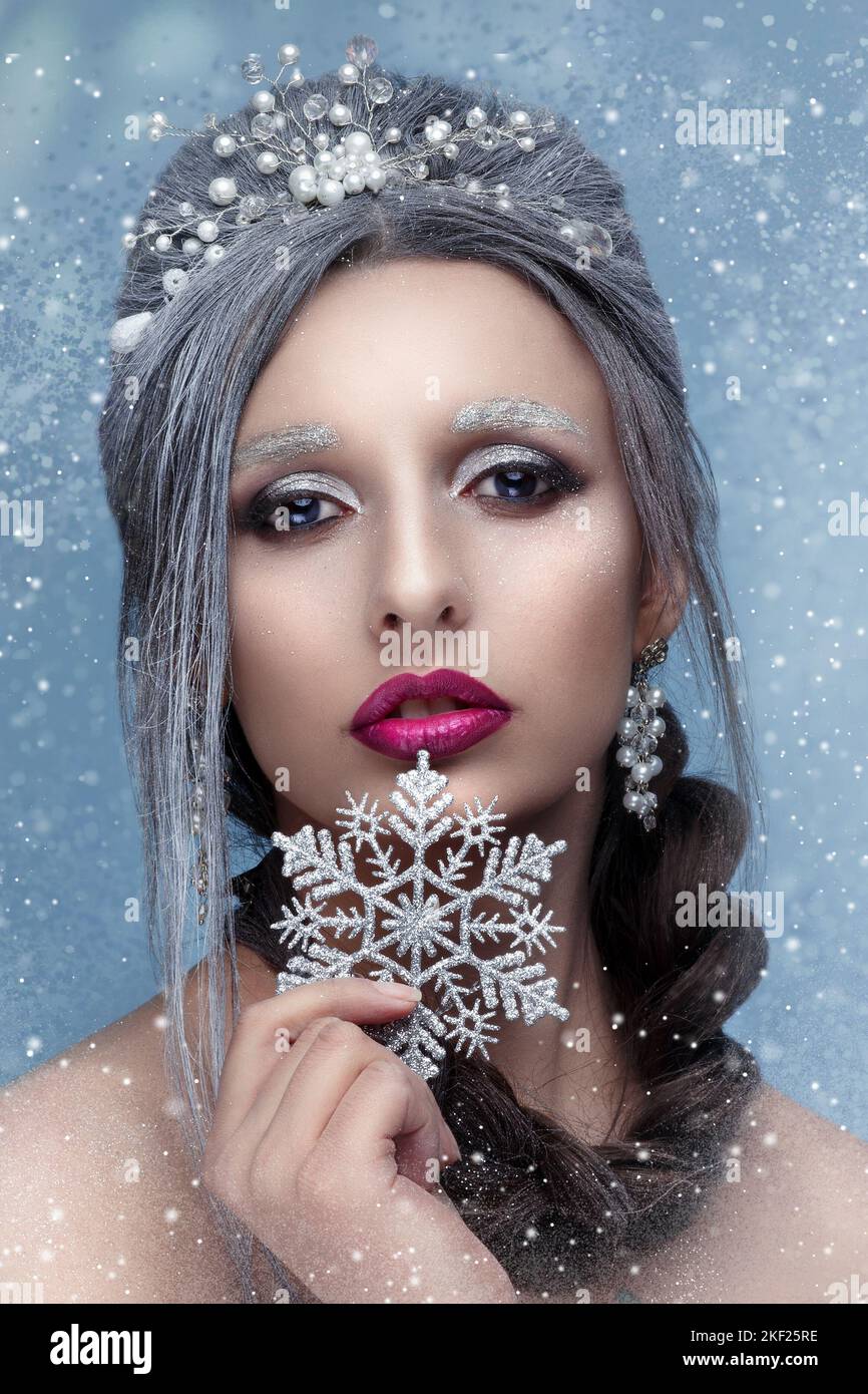 Beautiful snow queen. Fashion model woman with snow hair style and make up. Holiday makeup. Winter art Stock Photo