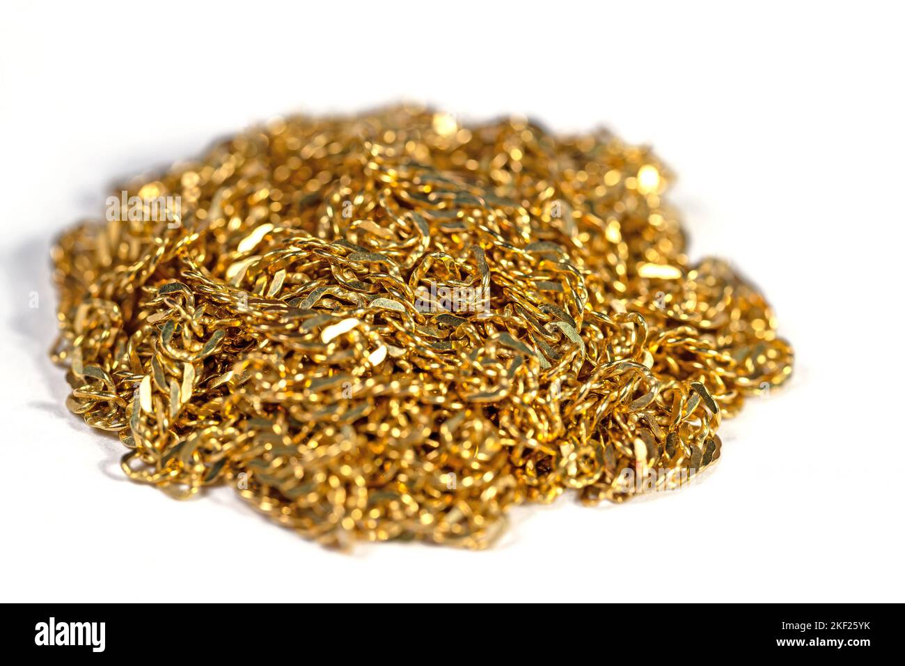 Golden chain links against white background Stock Photo