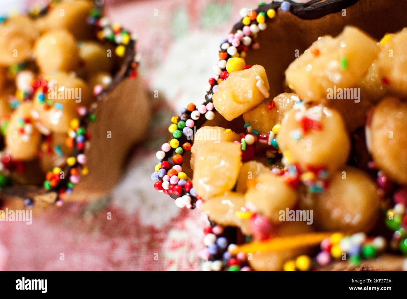 Struffoli in crunchy wafer, traditional Neapolitan Christmas sweets, made by the chef of the city of Maddaloni (CE) Giovanna Esposito. Stock Photo