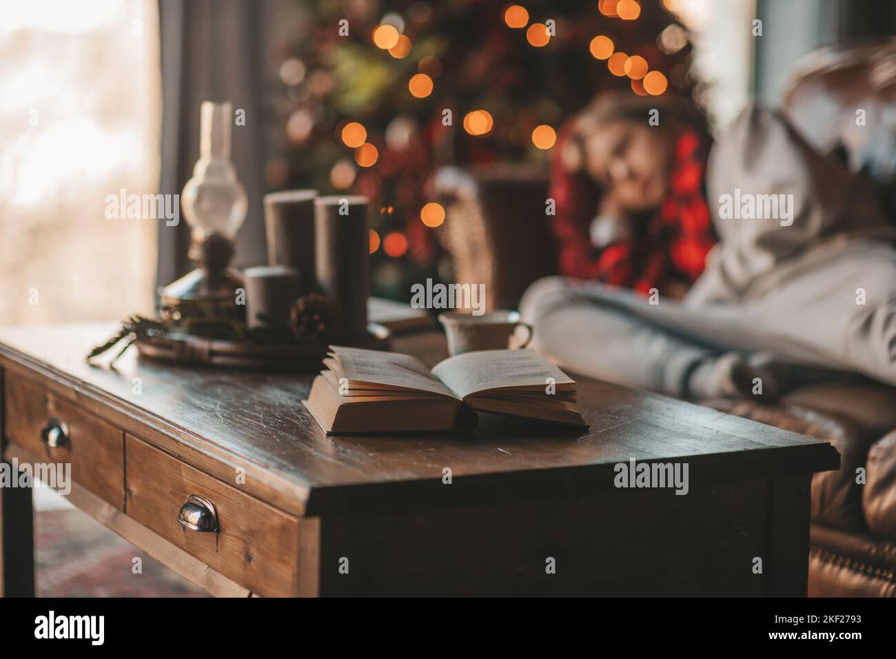 Young teen boy with long hair holding and reading study book for ...