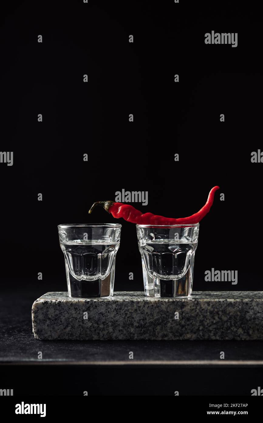 Two shots of vodka with red hot pepper Stock Photo Alamy