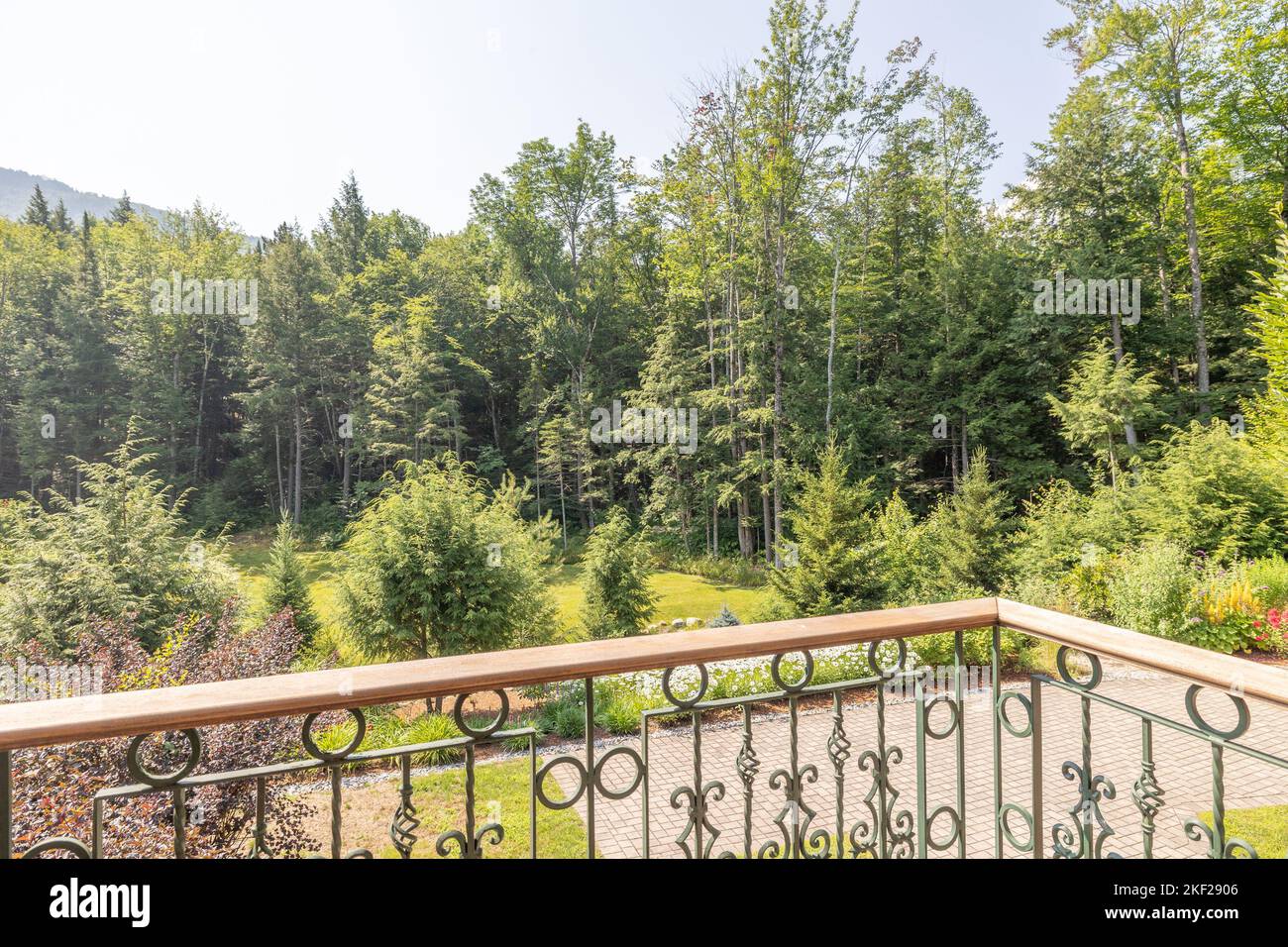 A balcony view of the woods from a mansion Stock
