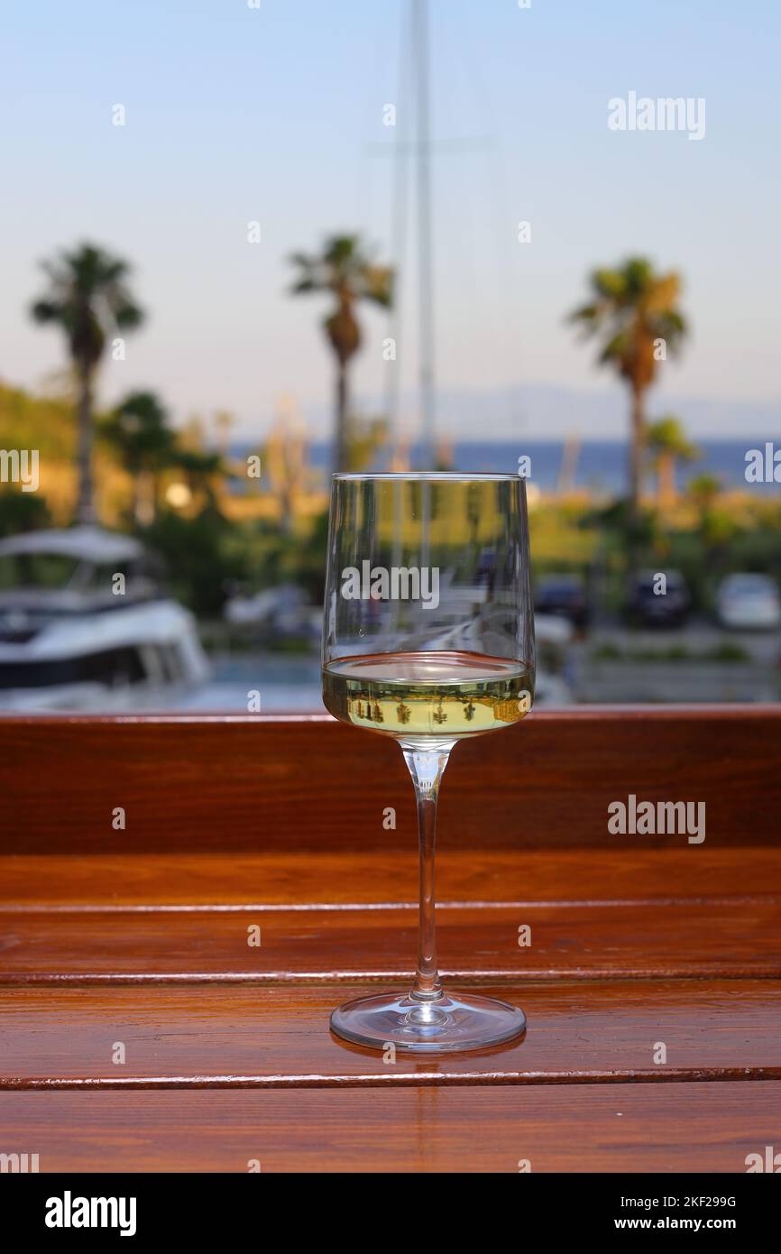 glass of white wine on the beach Stock Photo Alamy