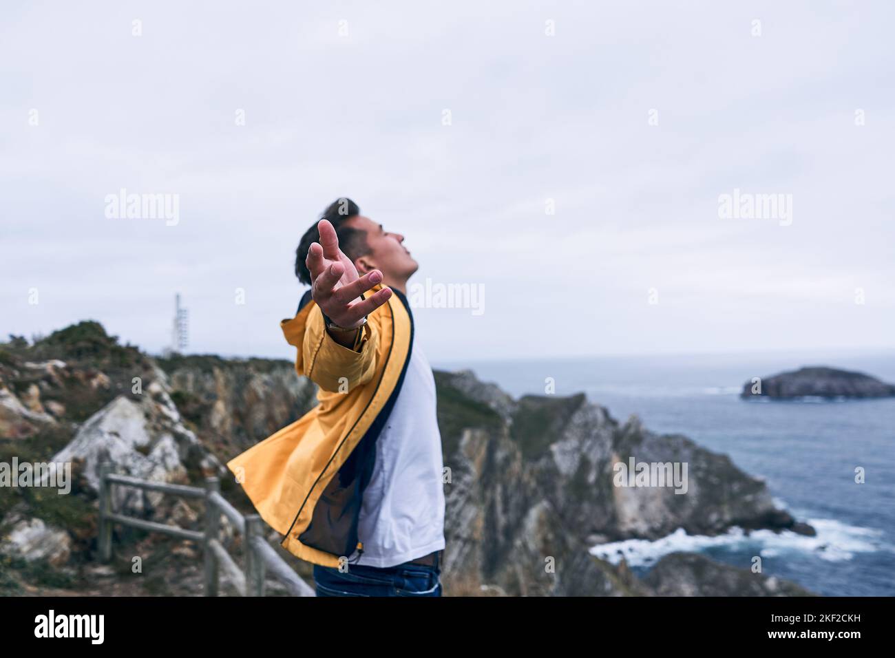 latin young man with white tshirt and yellow jacket closed eyes calm