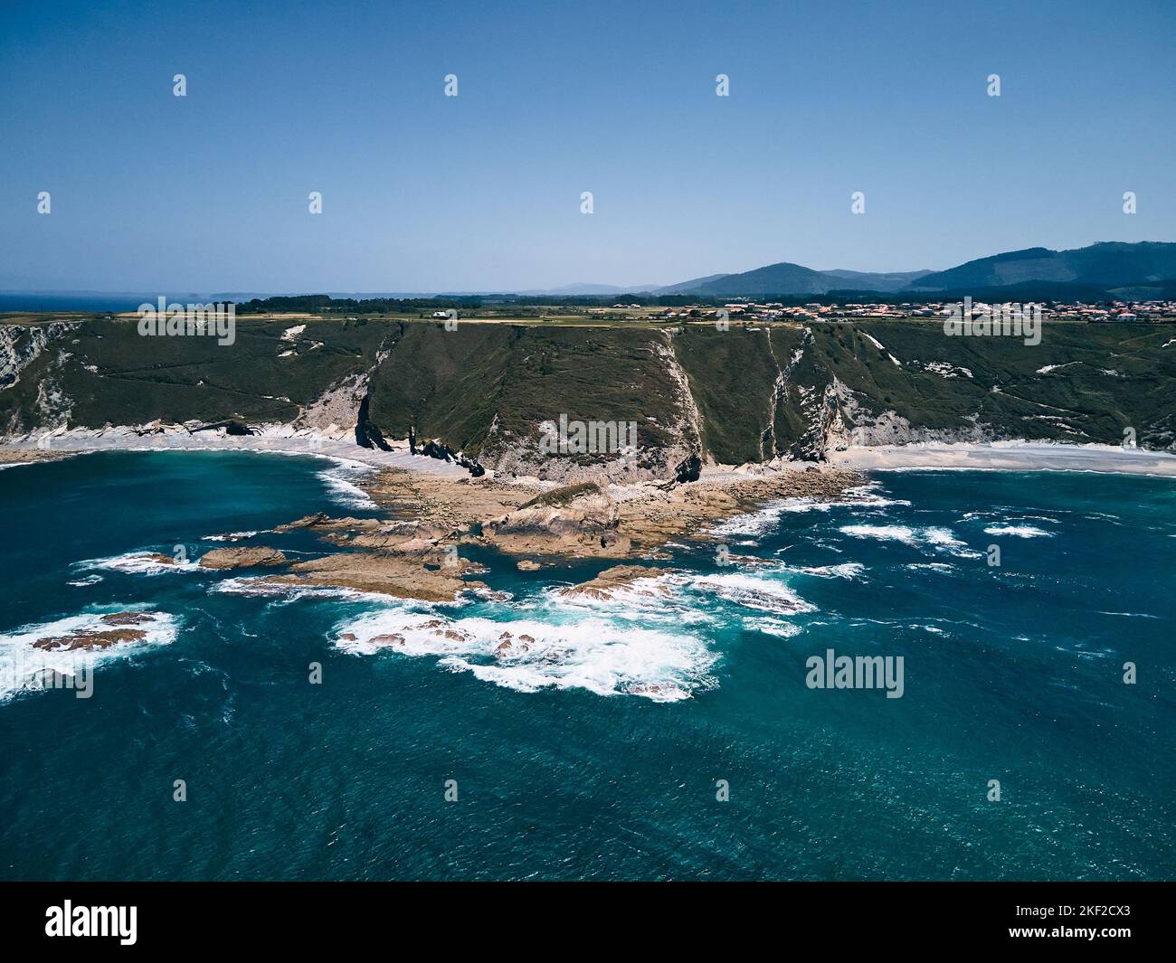 image taken with a drone from the sea of the impressive waves of the sea crashing against the rocks of the coast of the Cantabrian Sea, Asturias Stock Photo