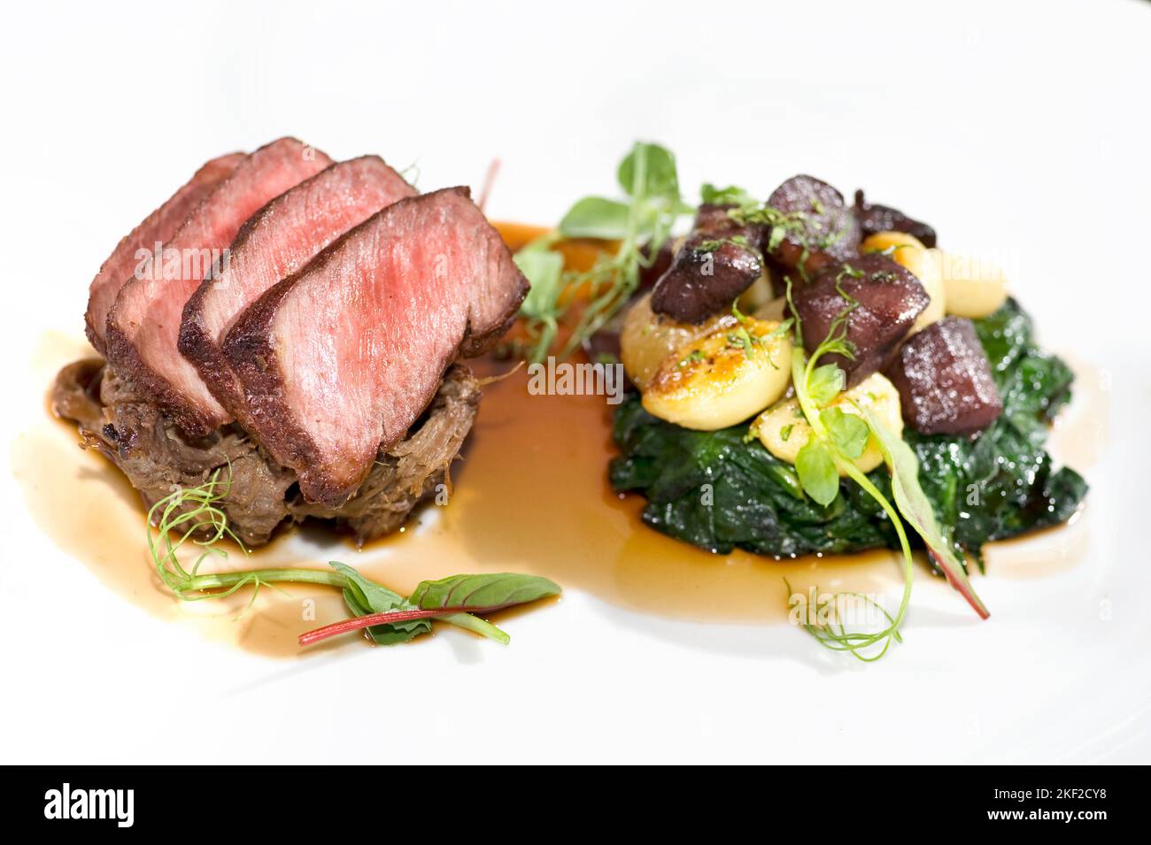 Seared beef with potatoes beets and spinach Stock Photo