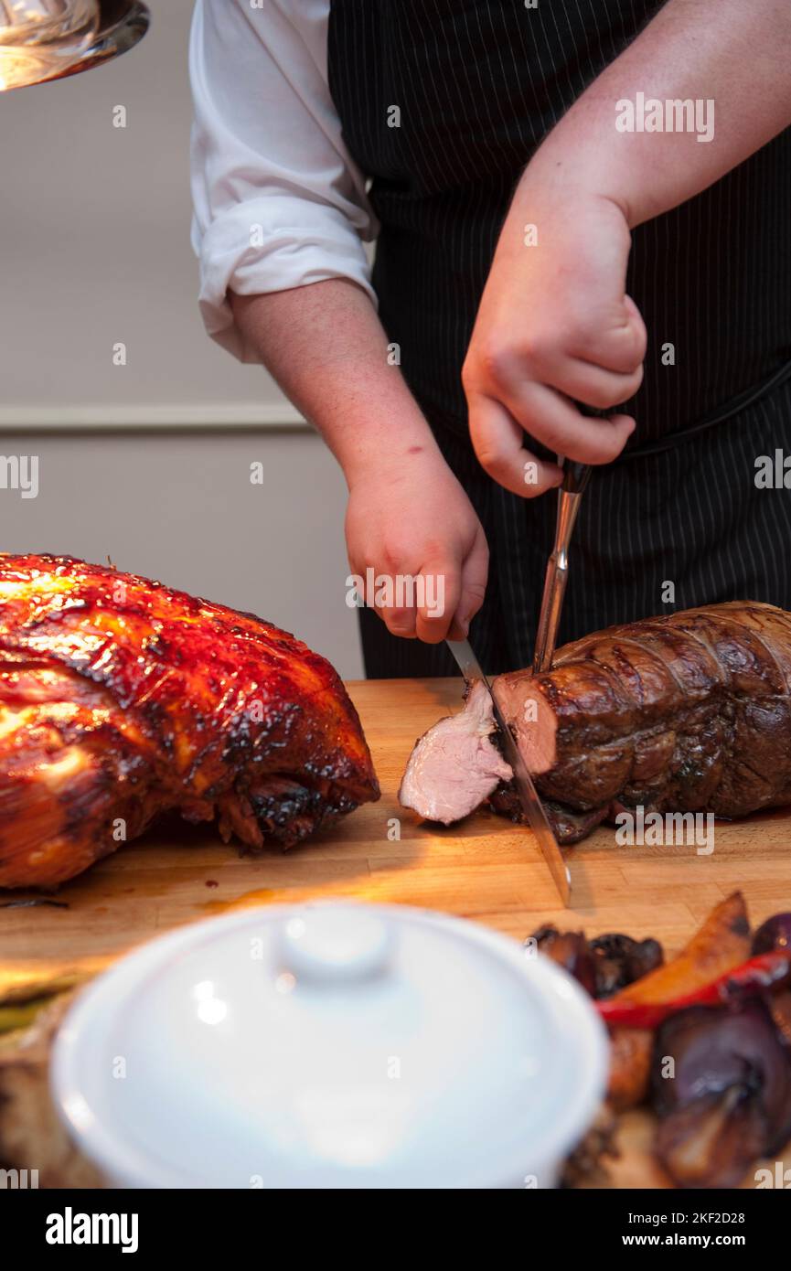 Chef Cutting salmon at buffet Stock Photo