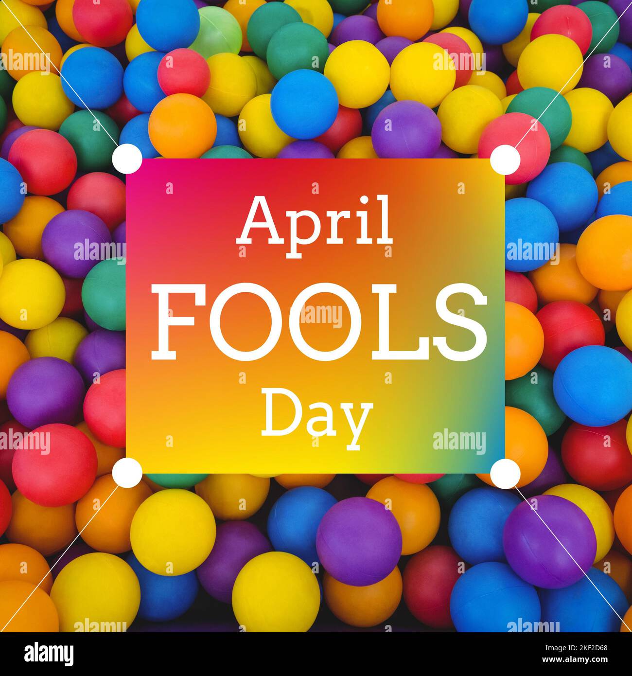 Composition of april fools day text over multi coloured balls Stock Photo
