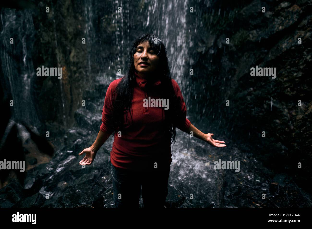 latin young woman with long hair wearing red sweater closed eyes with ...