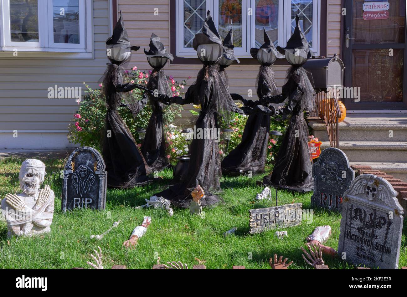 A house in Bayside, decorated for Halloween with dancing witches, skeletons, sculls & tombstones. In Queens, New York City, Stock Photo