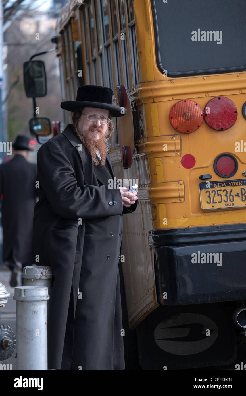 Portrait of an orthodox Jewish man, likely a Satmar rabbi, holding a book the Psalms. In Brooklyn, New York. Stock Photo