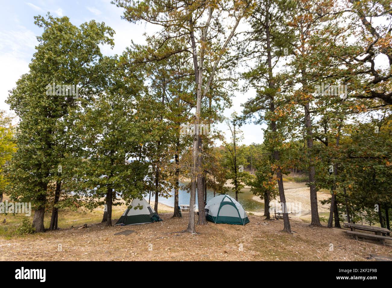 Camping tents near a beautiful lake among trees, campsite, adventure vacation concept, Broken